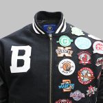 Detailed close-up of embroidered logo and chenille patch on varsity jacket