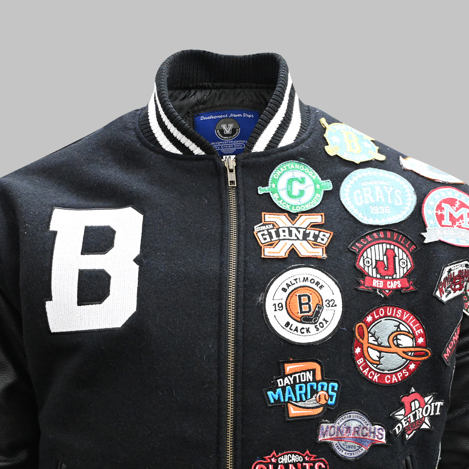 embroidered-letter-detail Detailed close-up of embroidered logo and chenille patch on varsity jacket